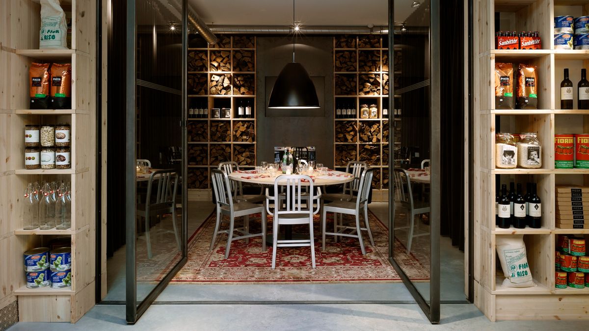 1006 Navy Chairs in brushed aluminium around a round table in a private dining room, Amsterdam — Courtesy Emeco