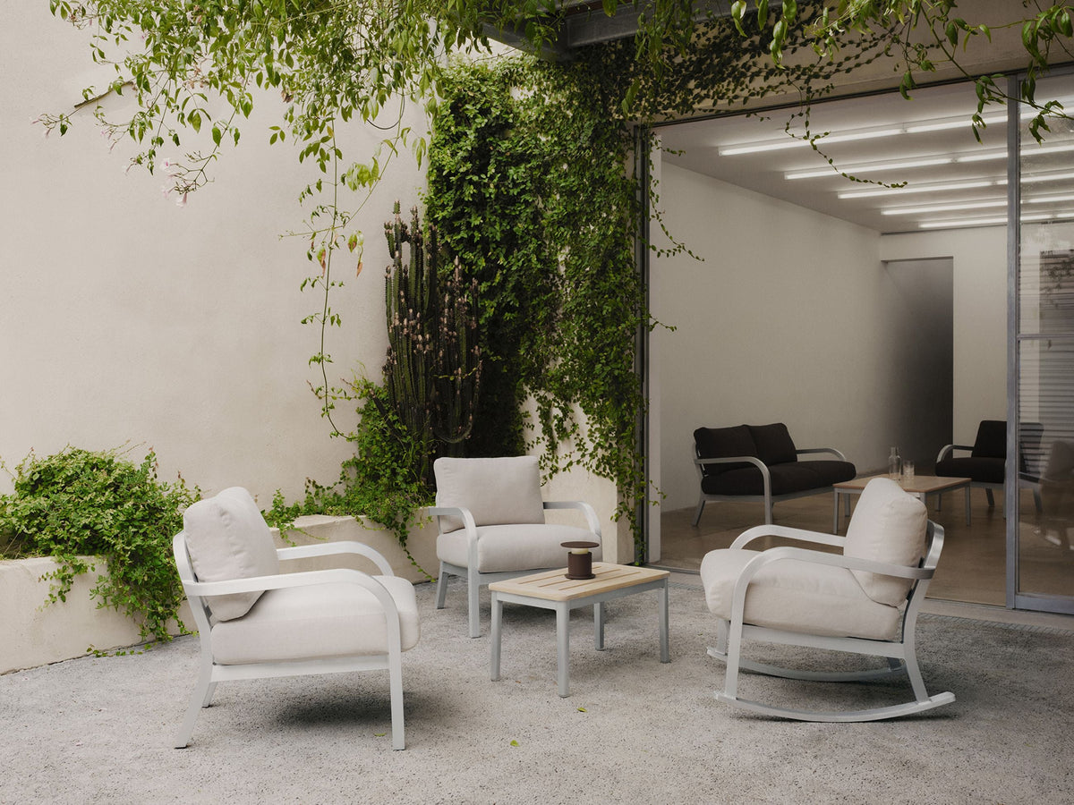 Emeco Navy Lounge chairs by Jasper Morrison in an indoor-outdoor garden setting