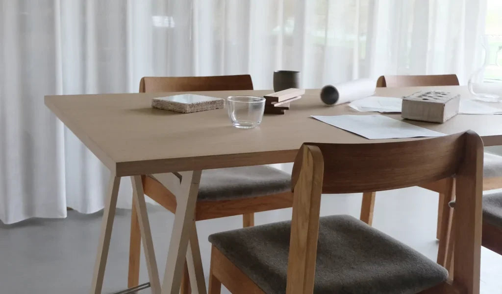 Form & Refine dining table and timber chairs in a light-filled Danish interior