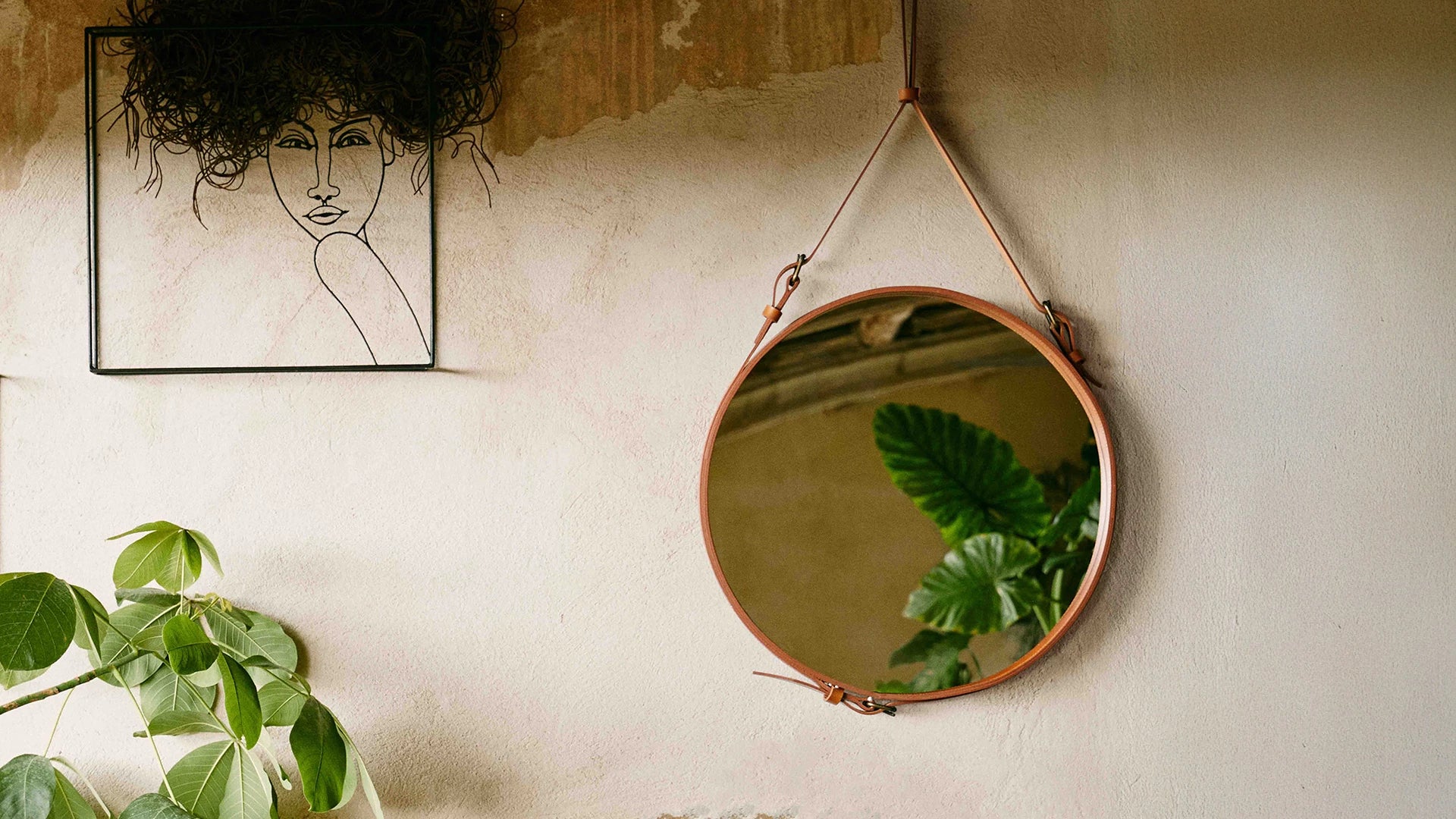 Adnet Wall Mirror, Circular by GUBI shown in an interior setting