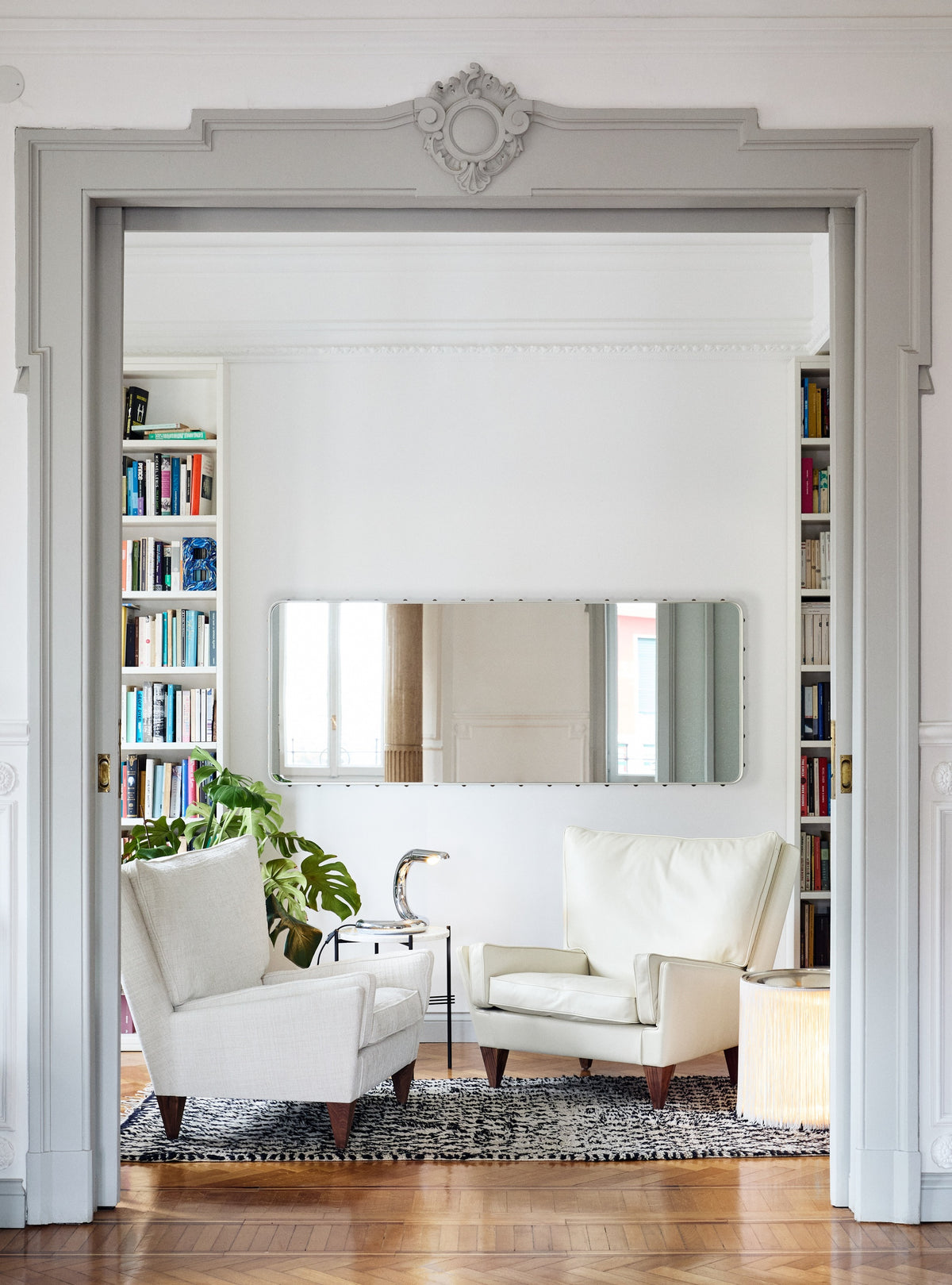 Adnet Wall Mirror by GUBI shown in an interior setting