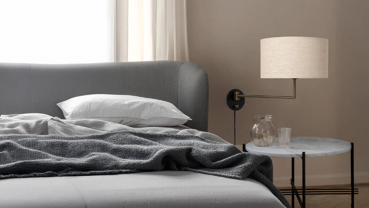 Gravity Wall Lamp by GUBI shown in an interior setting