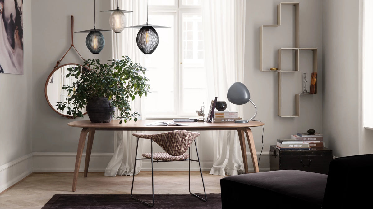 GUBI Dining Table - Elliptical by GUBI shown in an interior setting